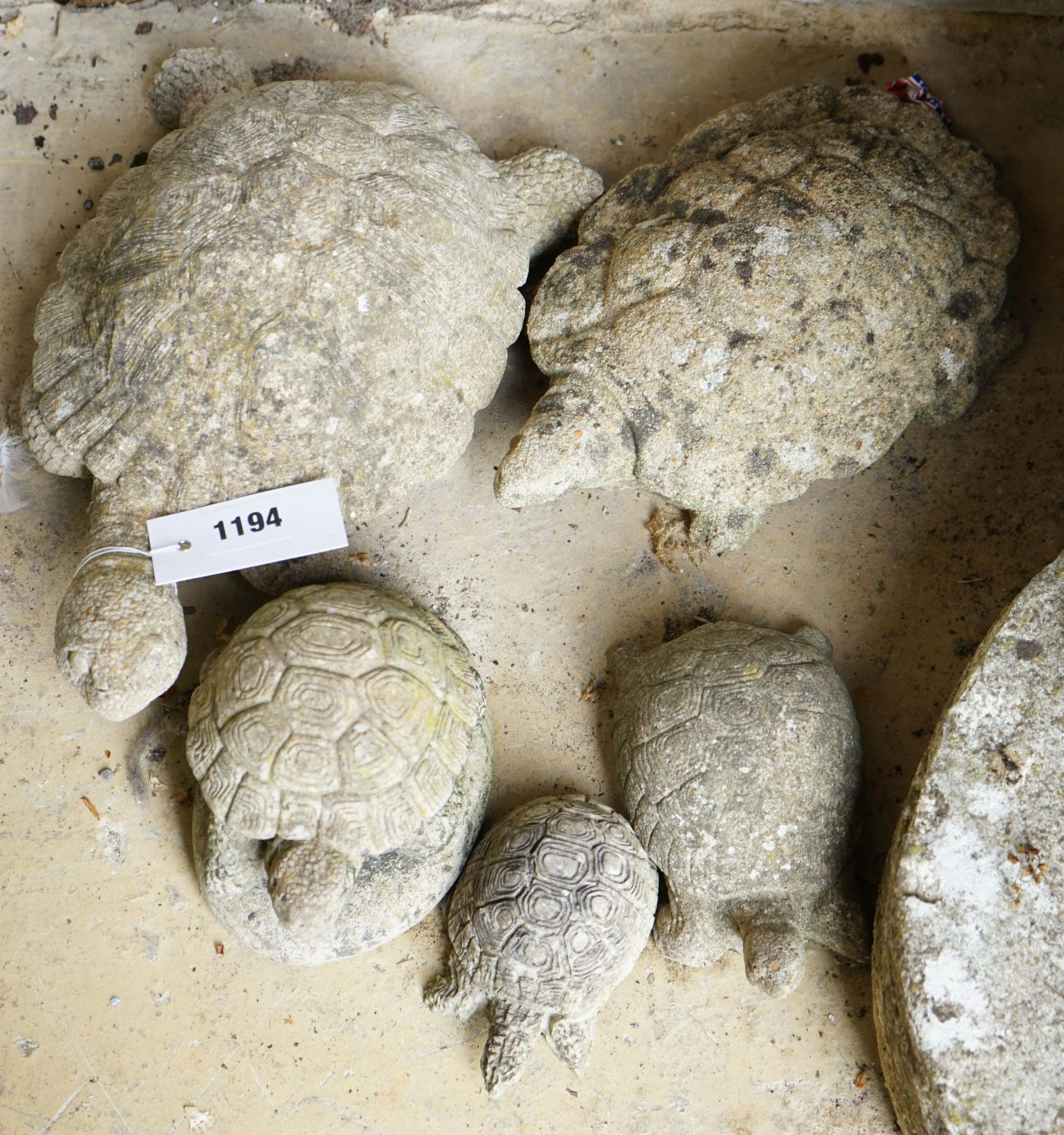 Five reconstituted stone tortoise garden ornaments, largest length 28cm